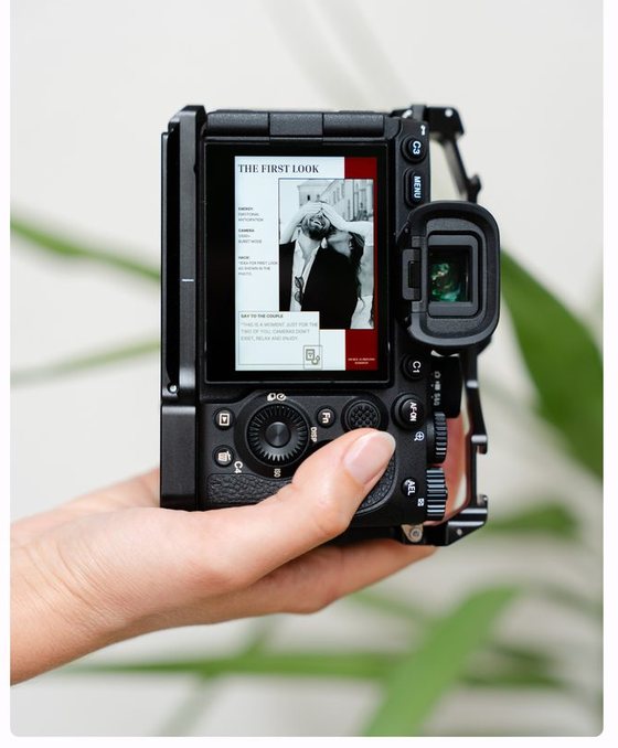 A pose card displayed on a camera's back screen, held in one hand